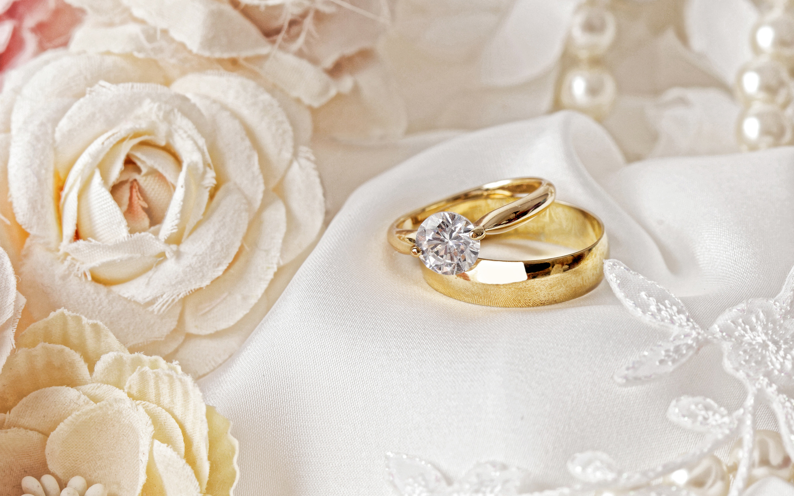 wedding-rings-wedding-concepts-gold-rings-roses-rings-on-silk-fabric.jpg